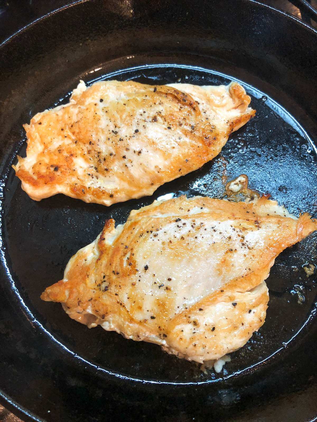 CHICKEN BREASTS COOKING IN A PAN
