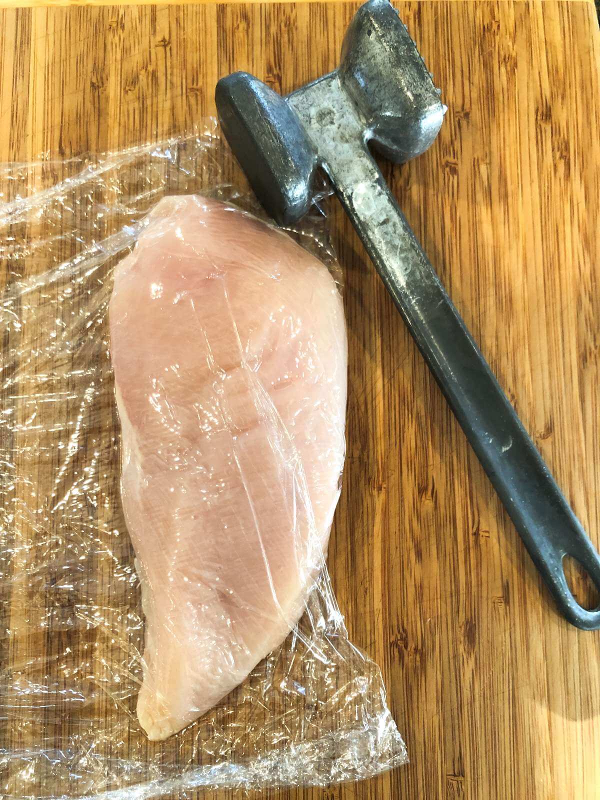 RAW CHICKEN BREAST WITH MALLET 
