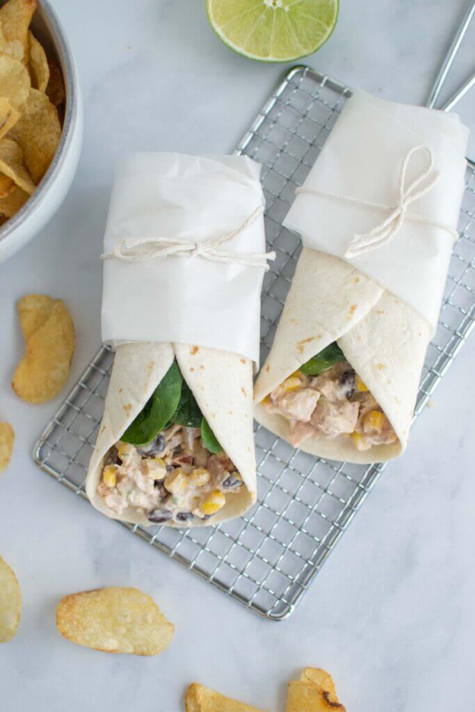 Two tex mex chicken wraps with potato chips