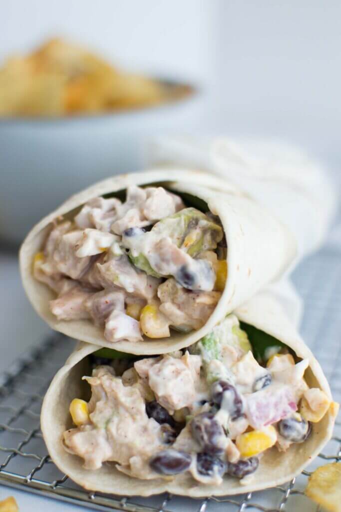 Two tex mex chicken wraps on a tray, close up