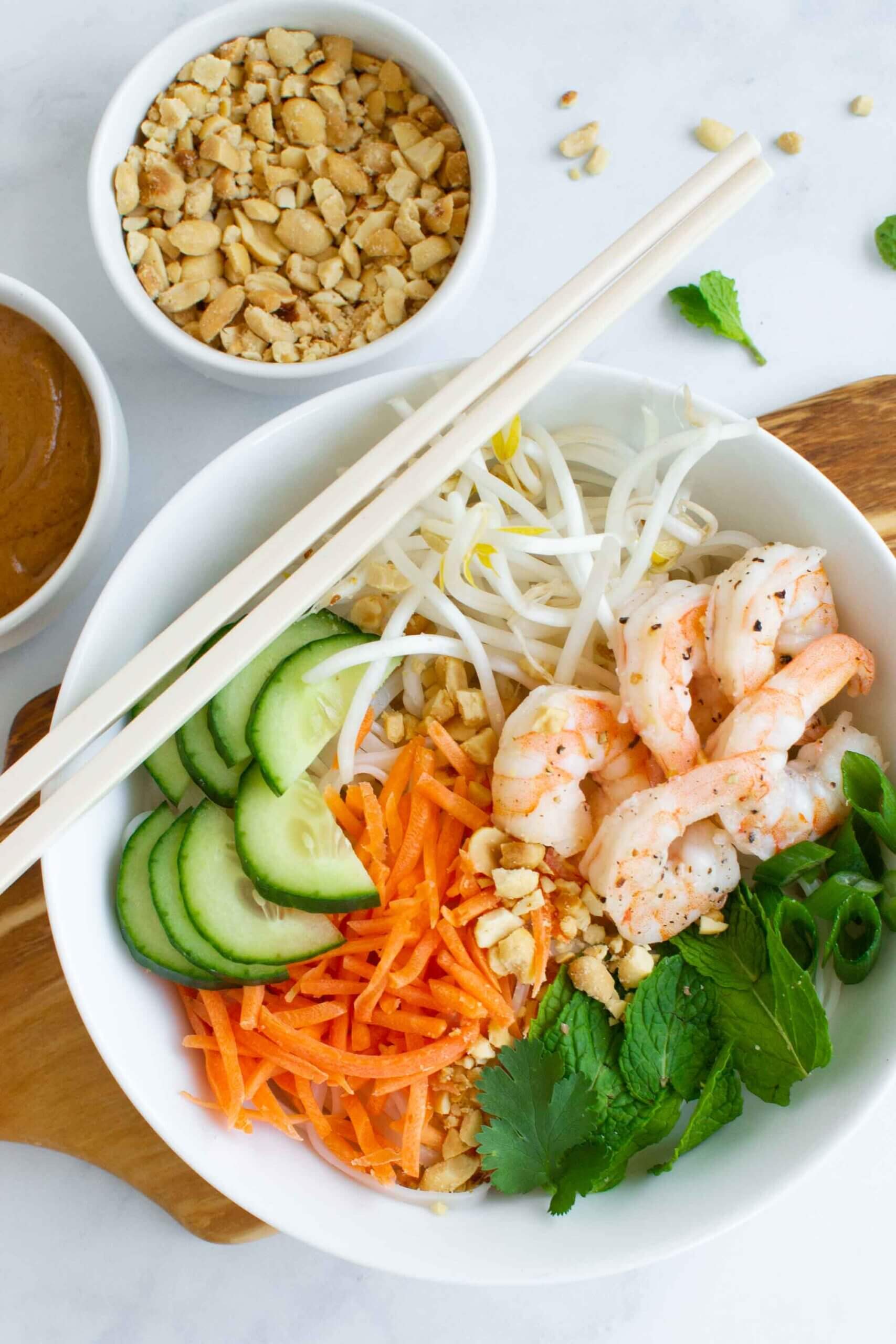 Vietnamese summer roll noodle bowl with peanuts, cucumber, fresh herbs and shrimp. 