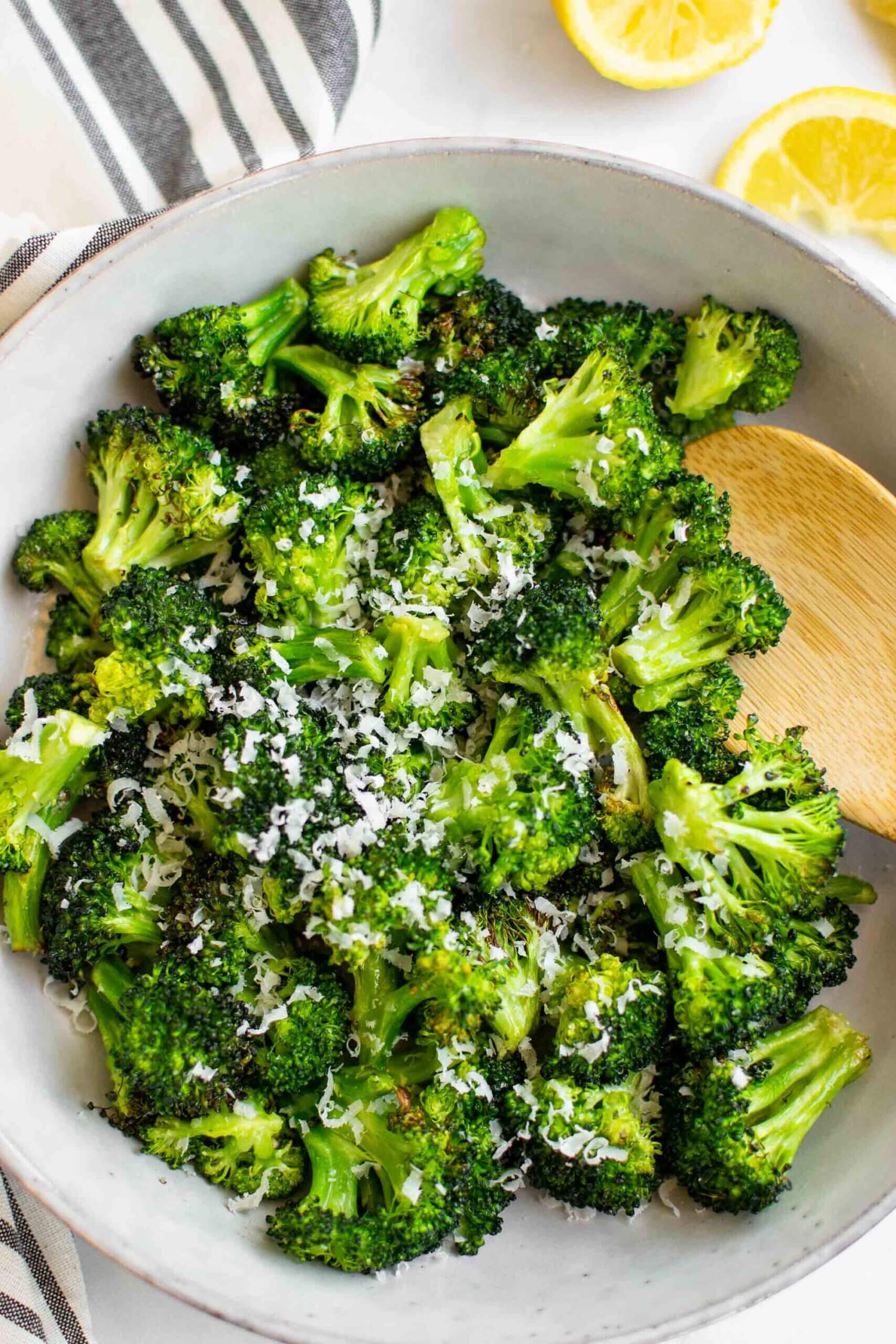 Air Fryer Roasted Broccoli in bowl topped with Parmesan cheese