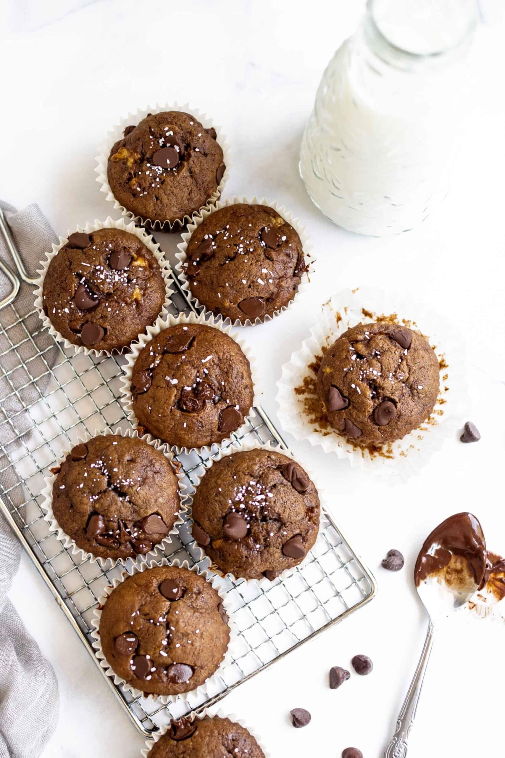 Easy double chocolate banana muffins on a tray with milk