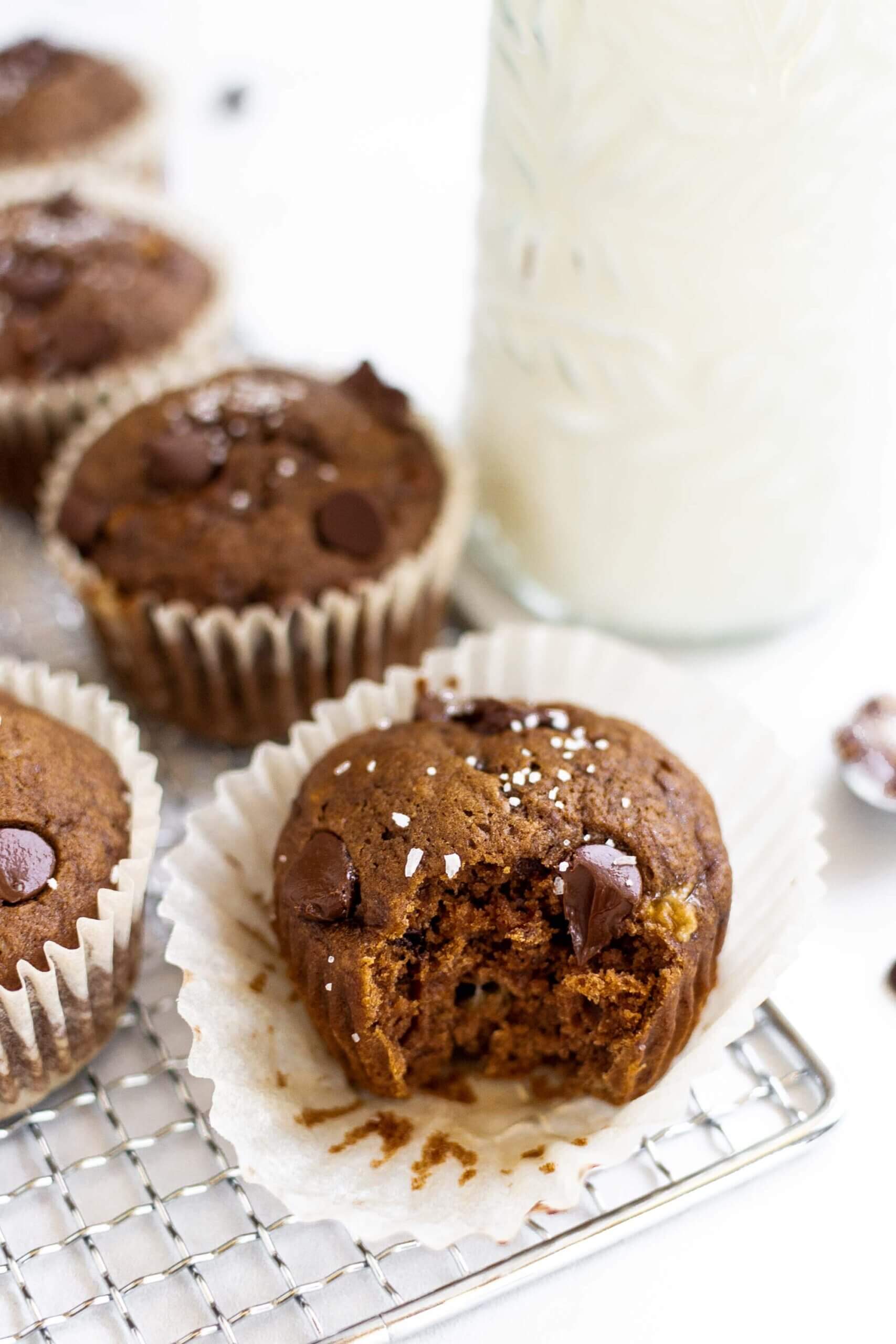 Easy double chocolate banana muffins on a tray with milk