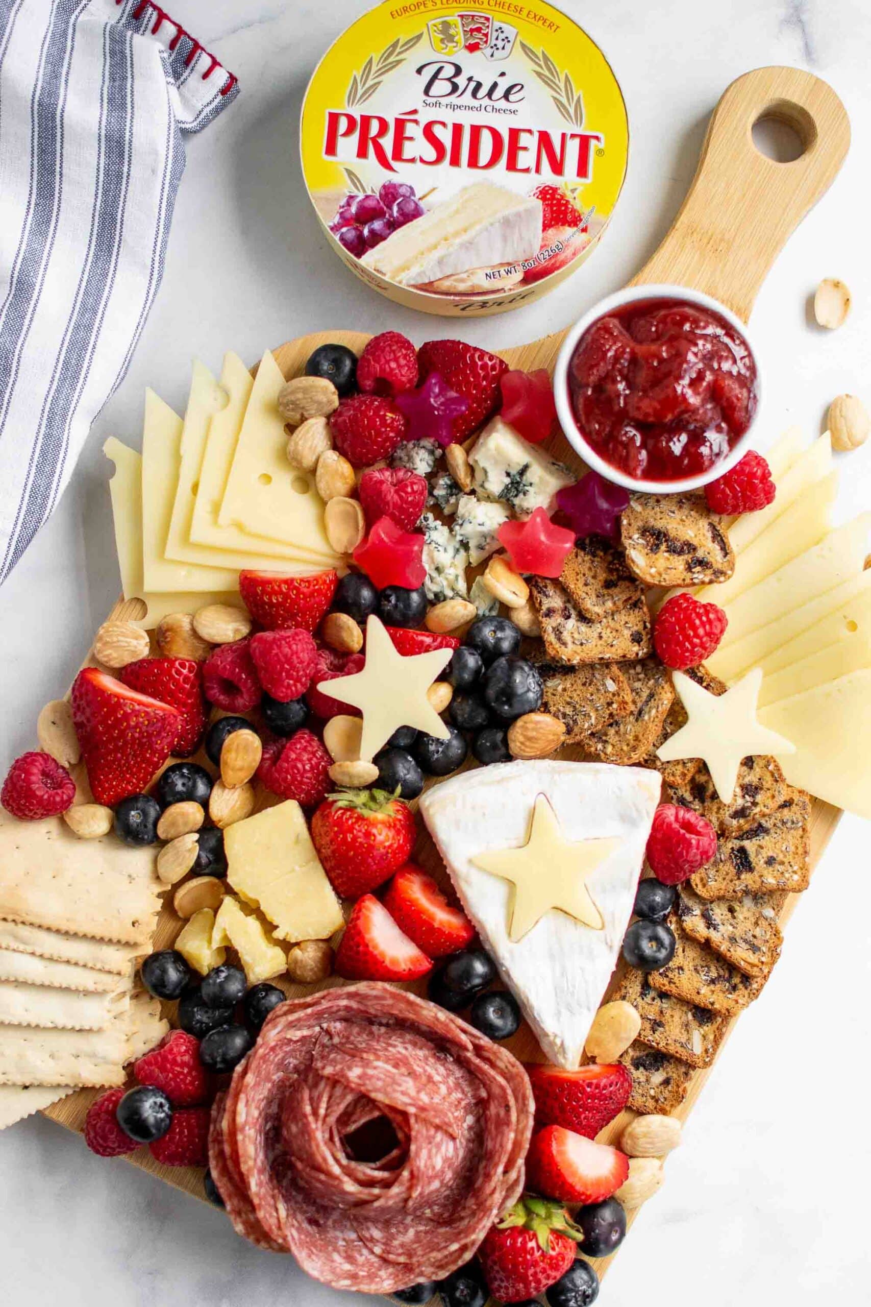 Red white and blue colored Patriotic Charcuterie Board with Président Brie container.