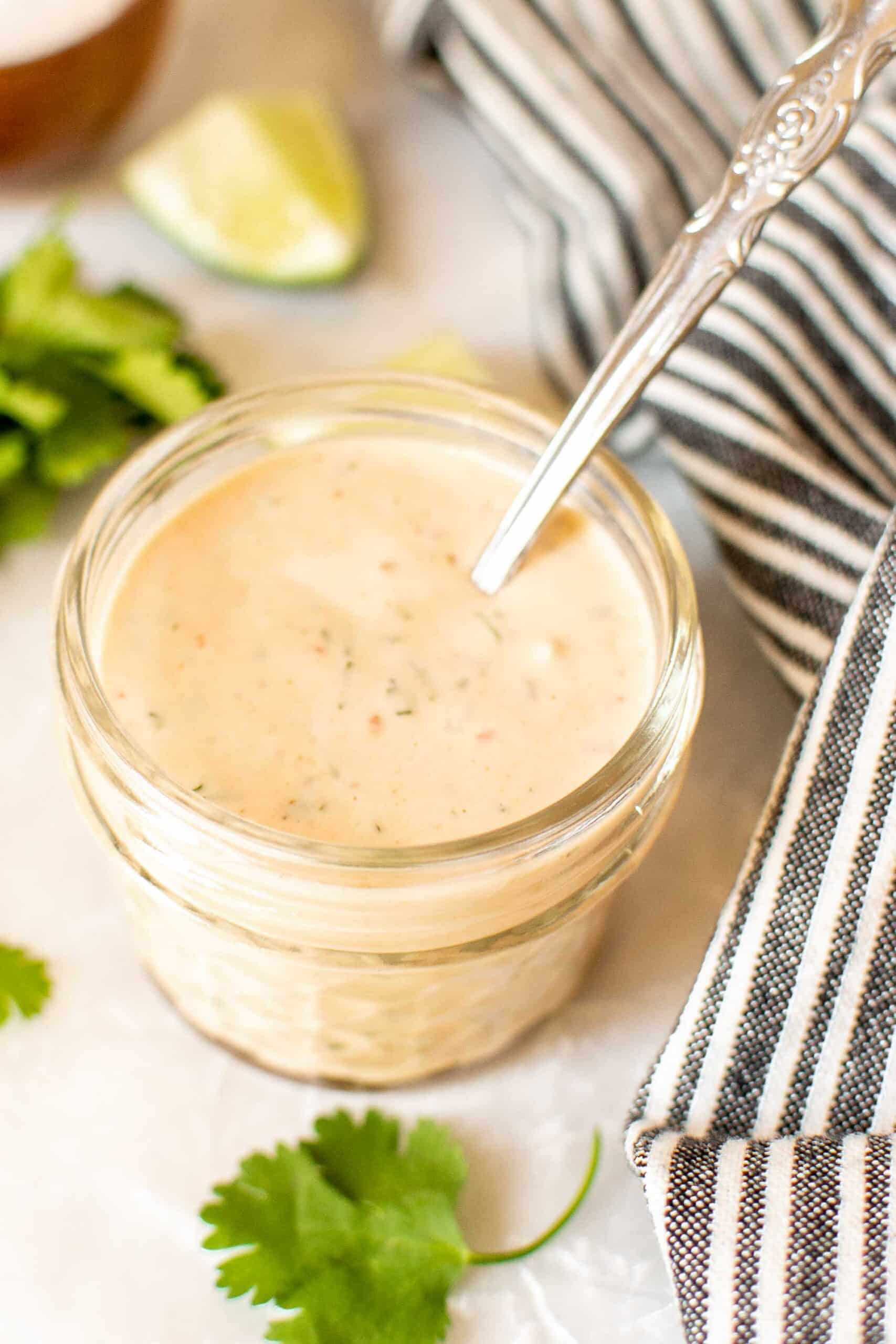 Creamy Chipotle Sauce and Salad Dressing in a jar with a spoon
