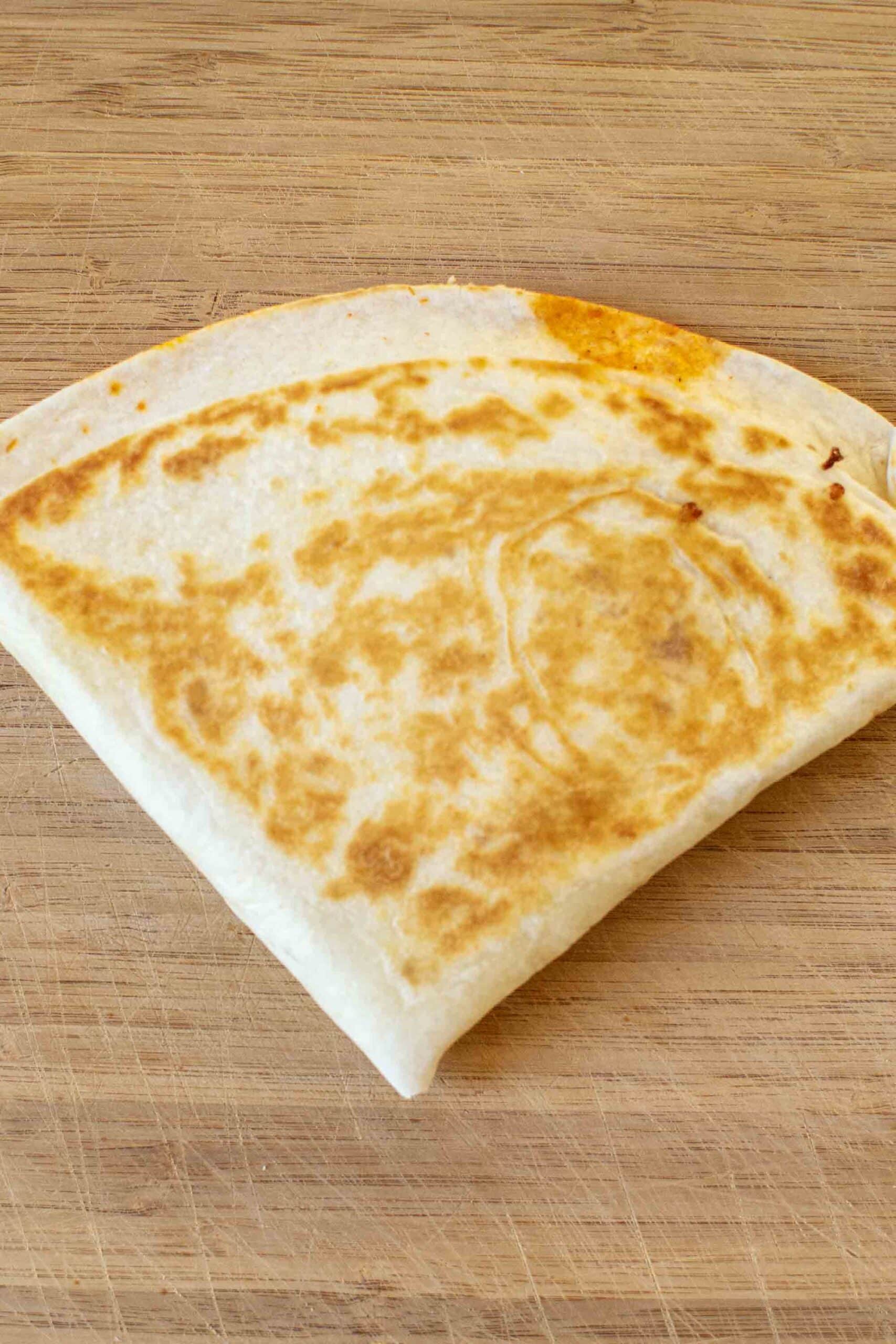 Step 5 of making a Pizza Tortilla Wrap or Pizza "Tortilla Trend." Fry it up until it's golden brown and cheese is melted.