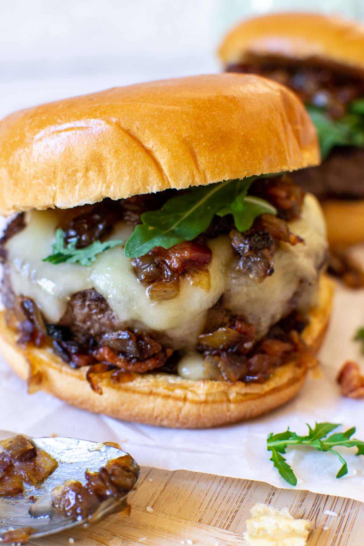 Brie burger with caramelized onions, cheese and arugula.