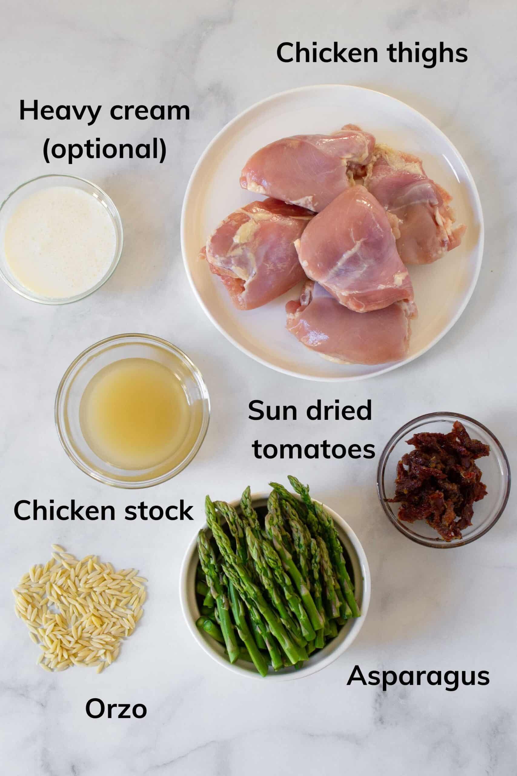 Photo of the 6 ingredients you need to make this creamy chicken orzo: Orzo, Chicken, heavy cream (optional), asparagus, sun dried tomatoes, and chicken stock