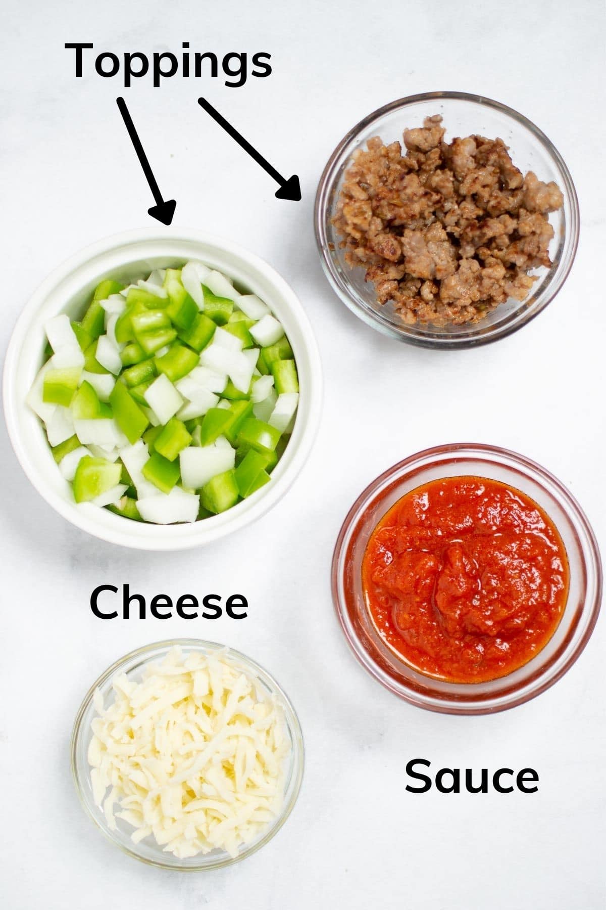 Ingredients needed to make pizza bowl: toppings (sausage and peppers and onions shown), sauce and cheese.