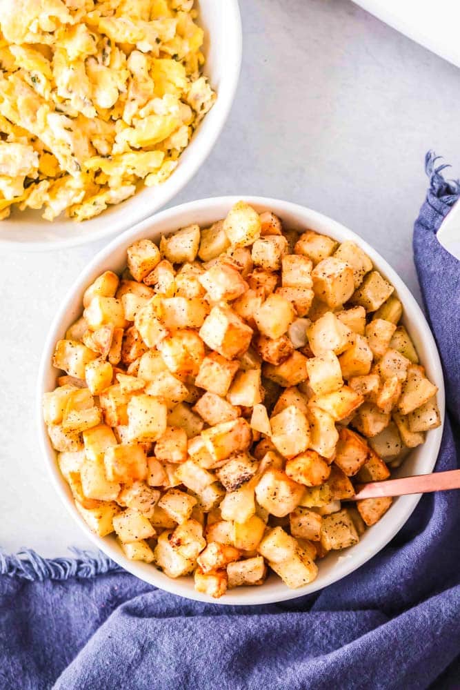 Frozen diced hash brown potatoes in a large serving bowl.