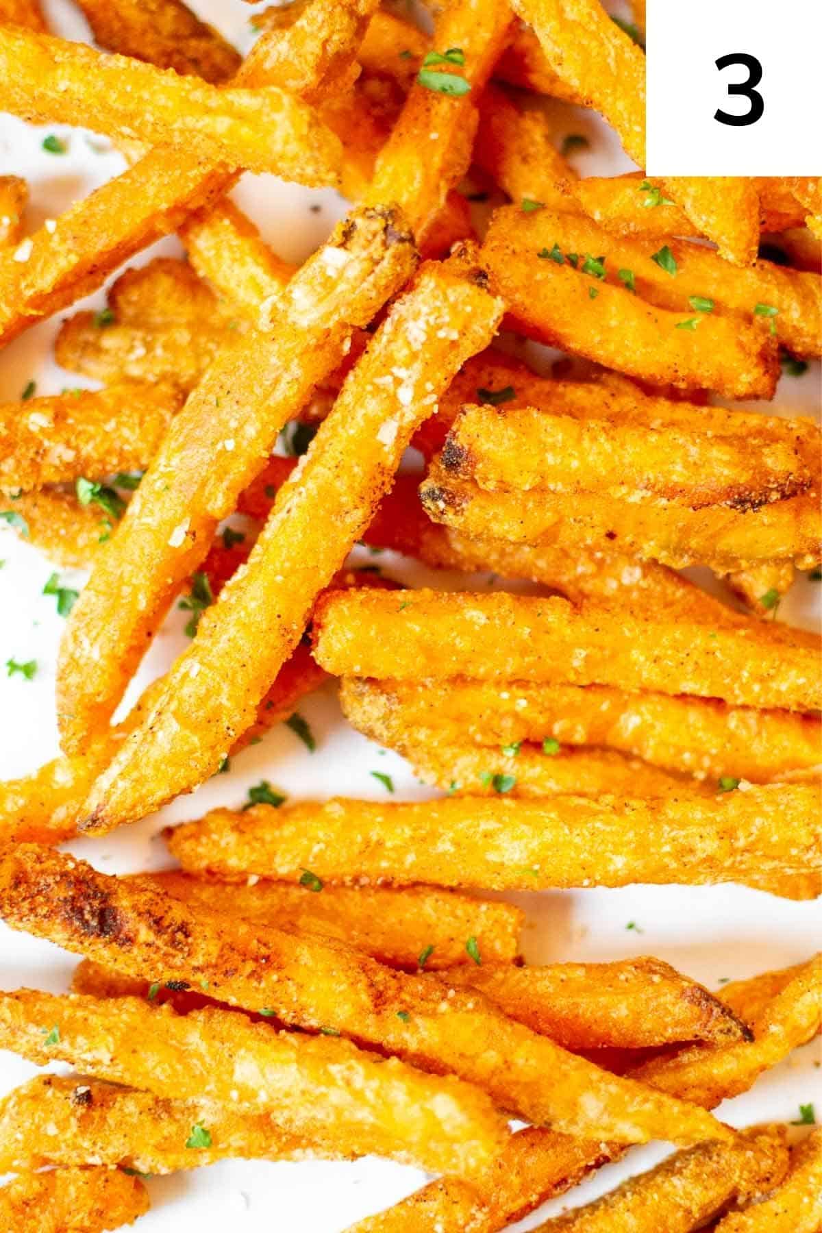 Cooked sweet potato fries with salt and parsley.