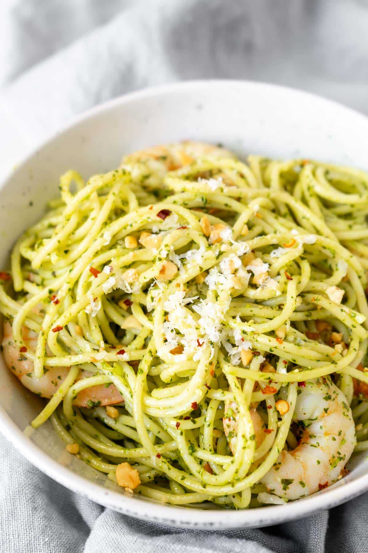 Cilantro lime pasta with shrimp on a white bowl.