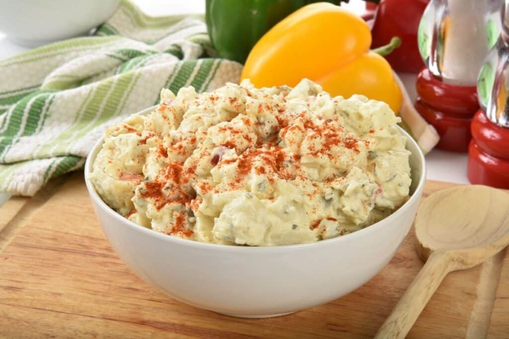 Potato salad in a bowl sprinkled with paprika