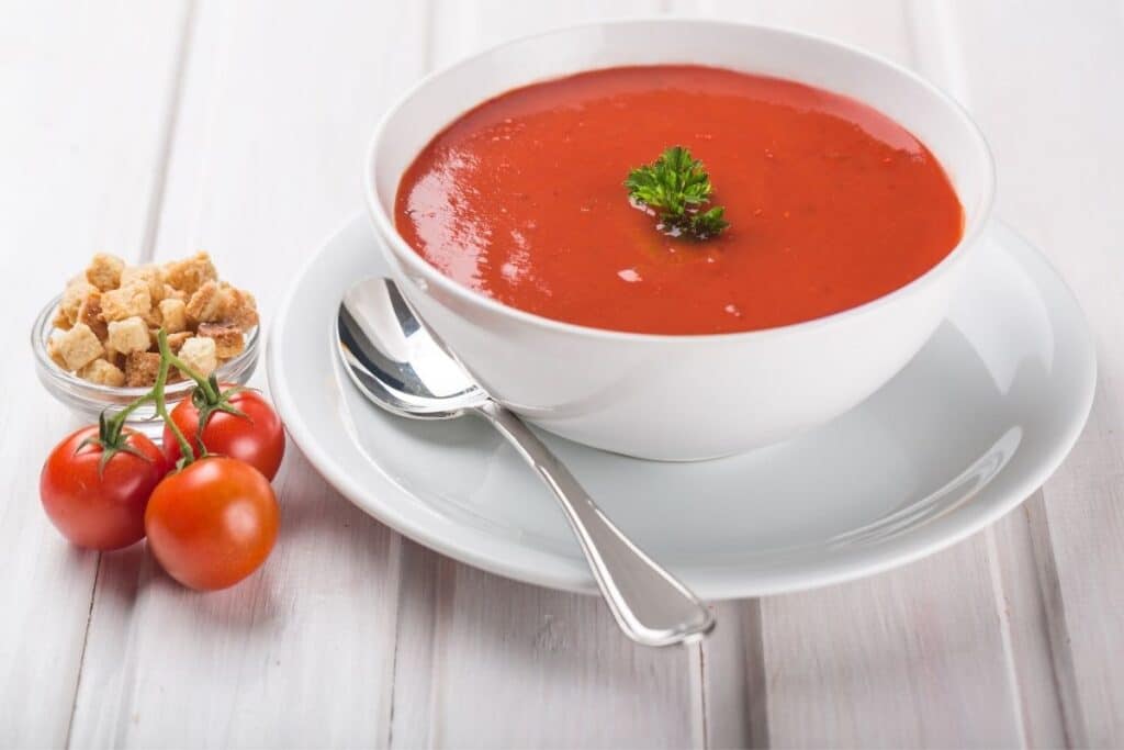 24 Easy Sides for Grilled Cheese:  Tomato soup in a white bowl.