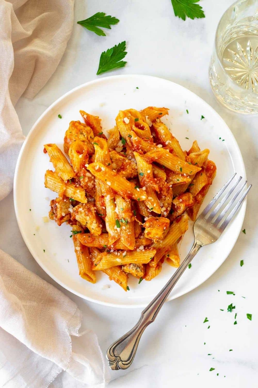 Instant pot chicken penne pasta in a white plate with a fork