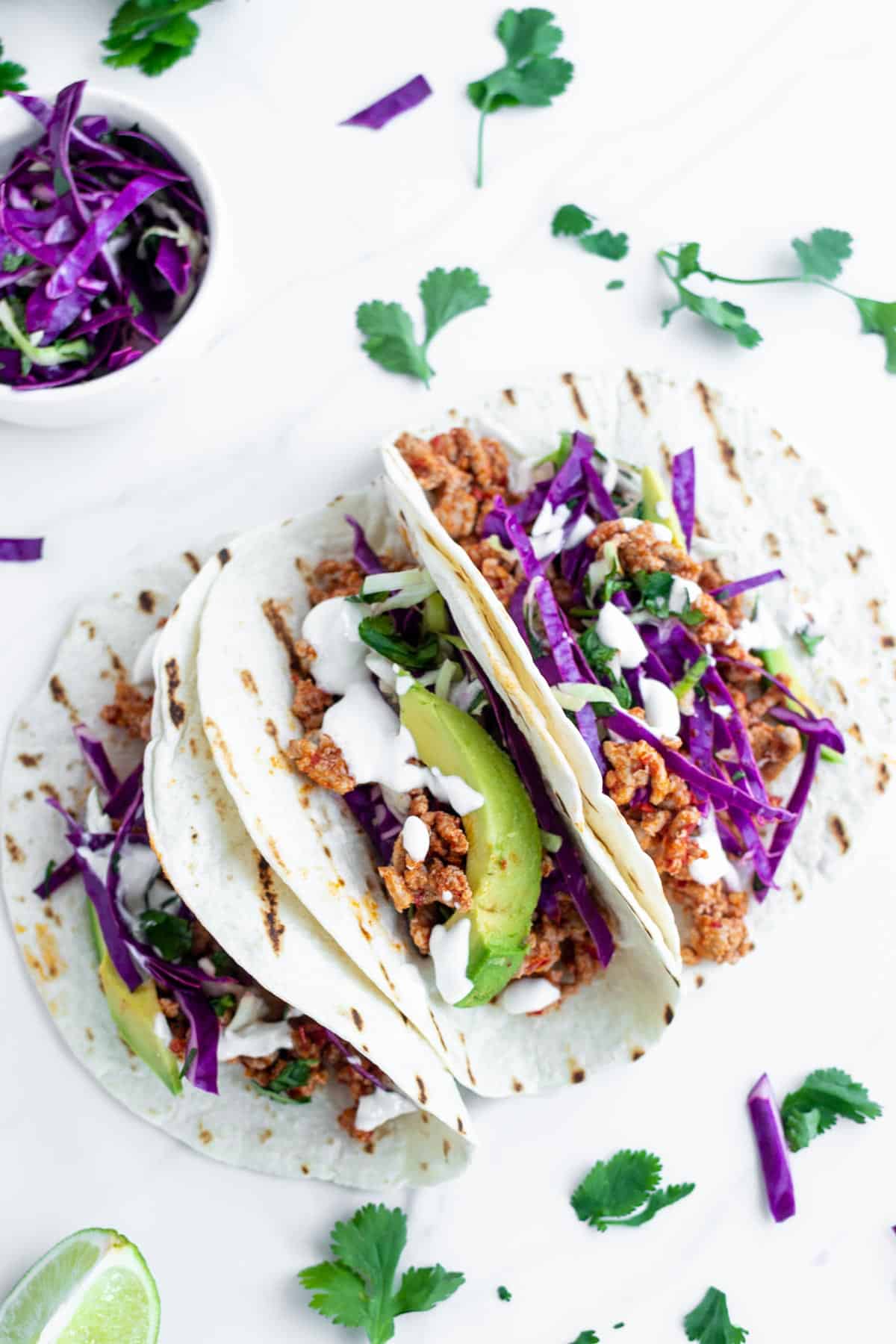 3 spicy ground pork tacos with purple cabbage slaw
