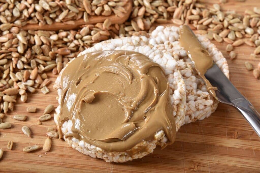 One of the best substitutes for almond butter--sunflower seed butter. Spread on a rice cake with butter knife.
