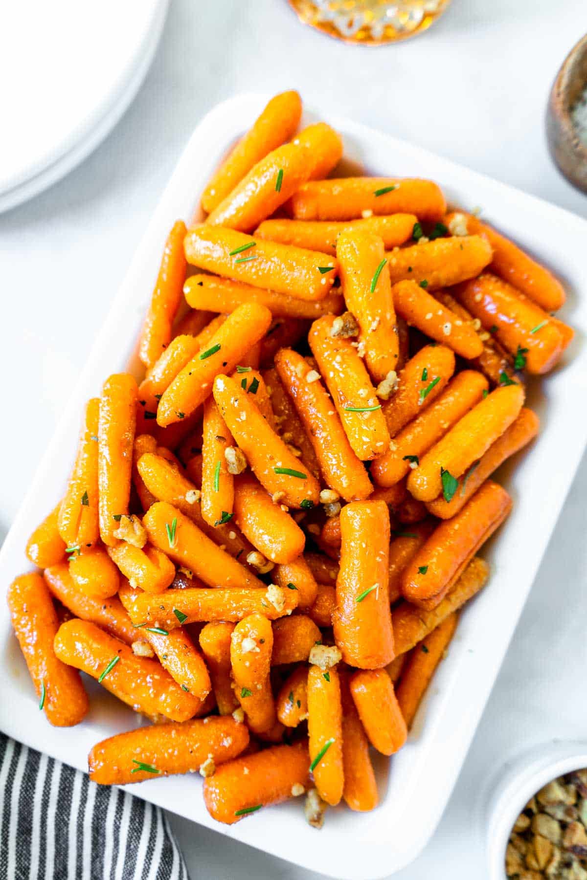 Air fryer roasted baby carrots on a white plate.