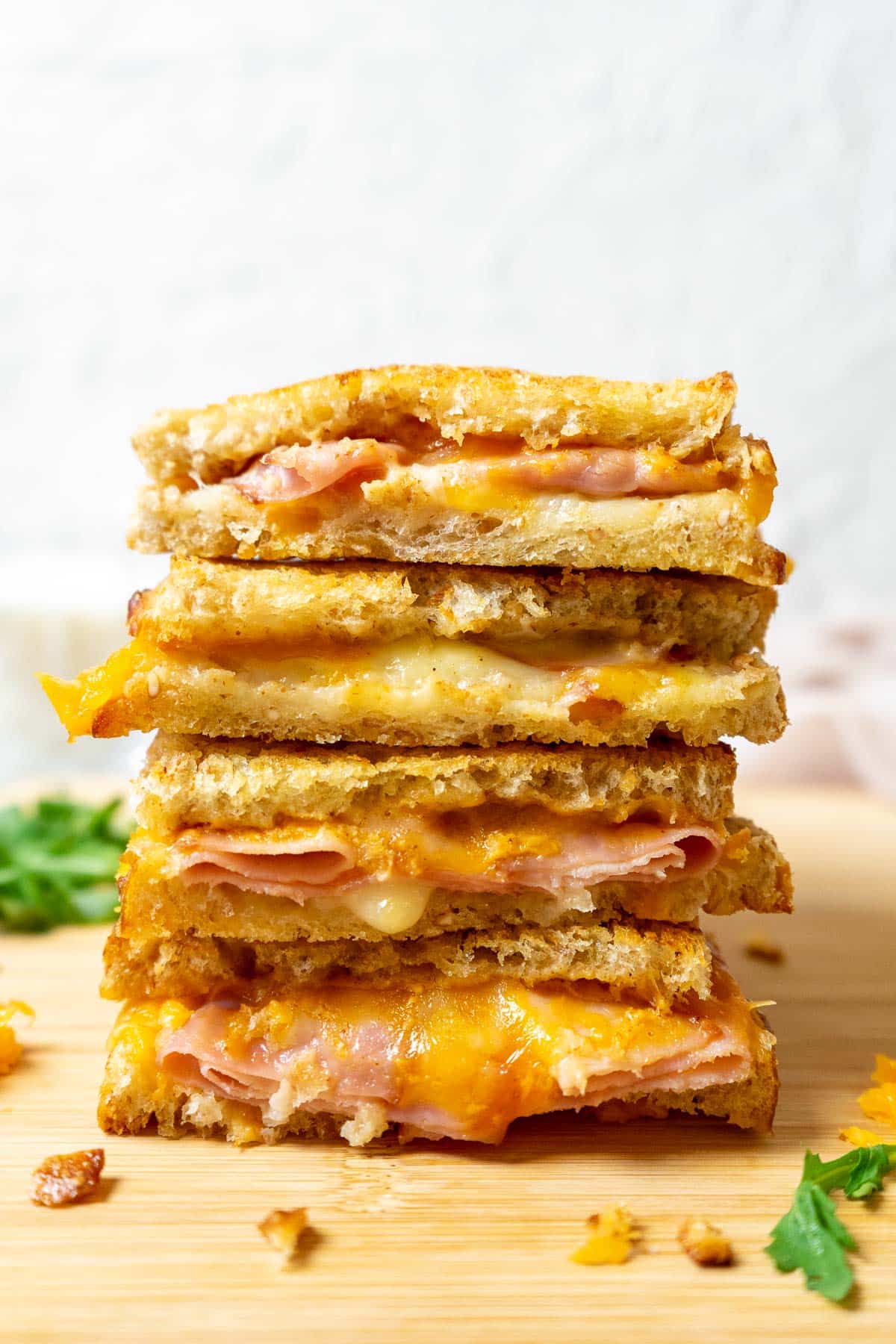 Air Fryer Grilled Ham and Cheese Sandwiches stacked on top of one another.