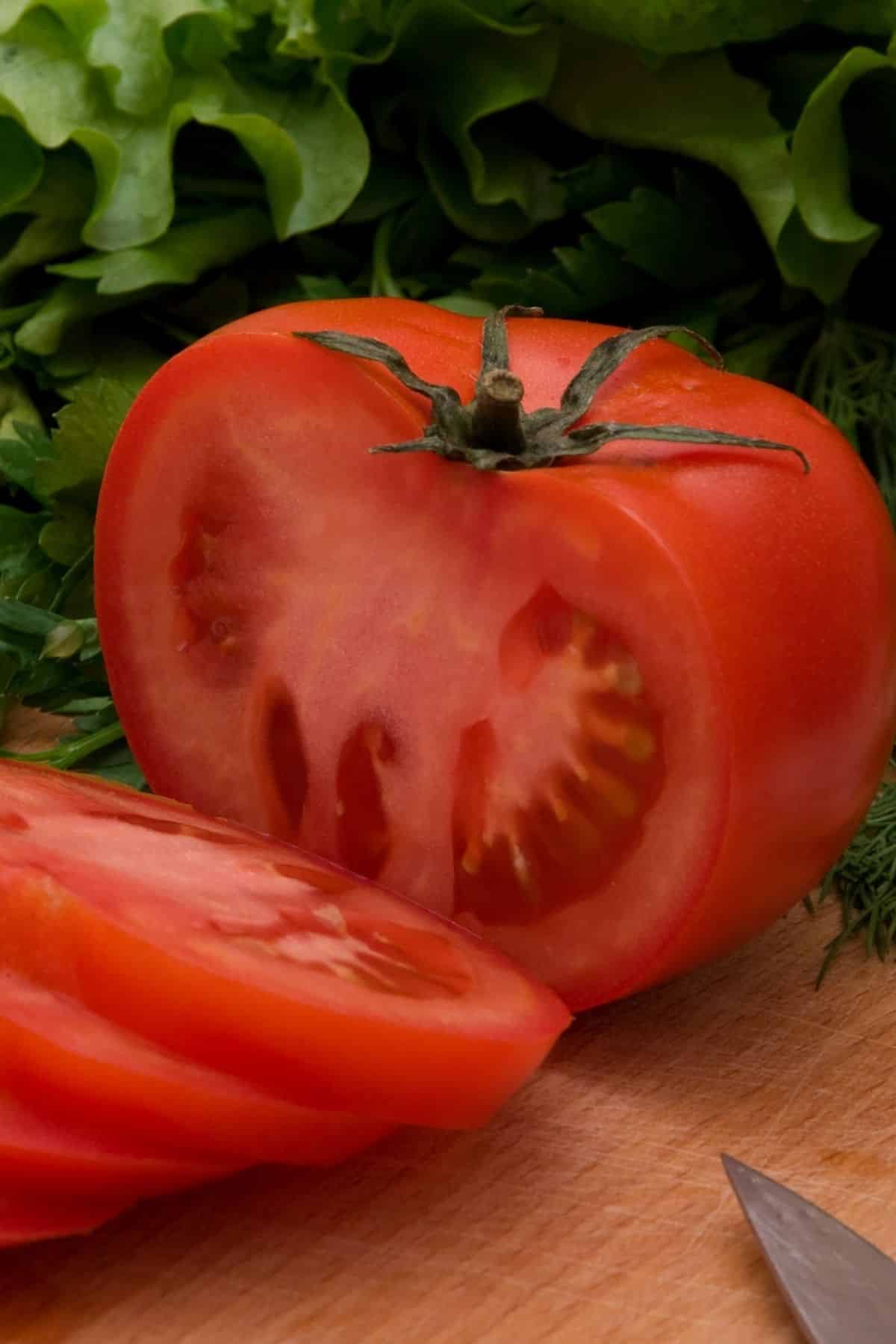 A large tomato cut into slices.