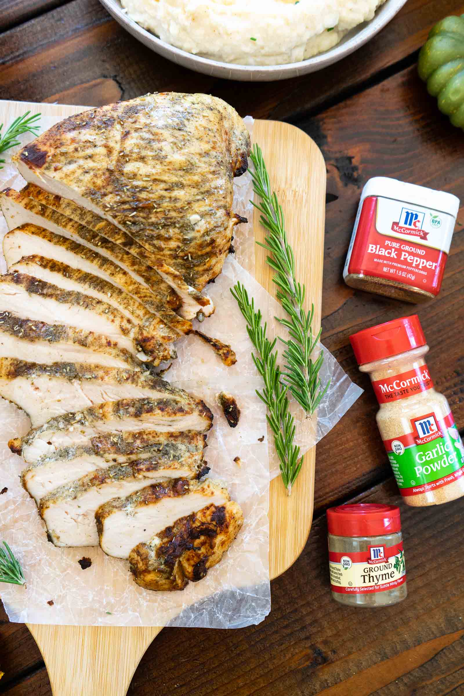 Air Fryer Roasted Turkey breast cut on a cutting board with McCormick spices