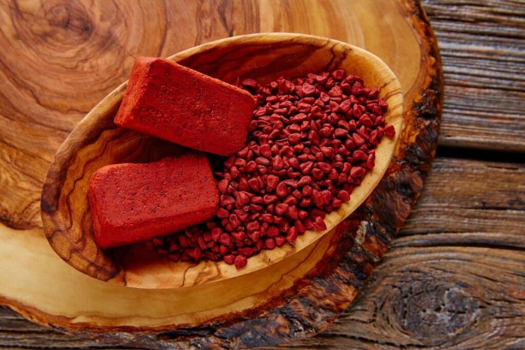Substitutes for Turmeric: Annatto in a wooden bowl.