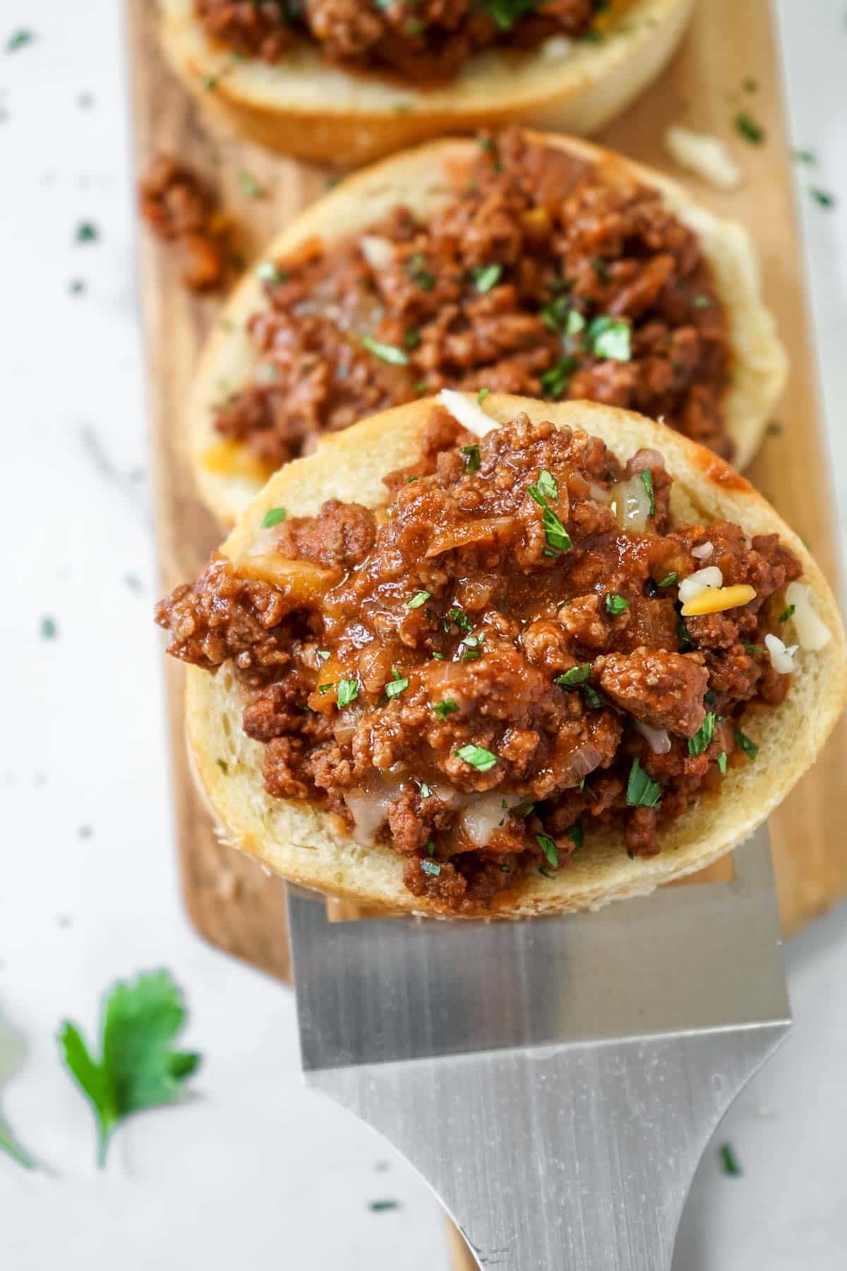 Close up of one slice of sloppy joes on Texas toast on an spatula.