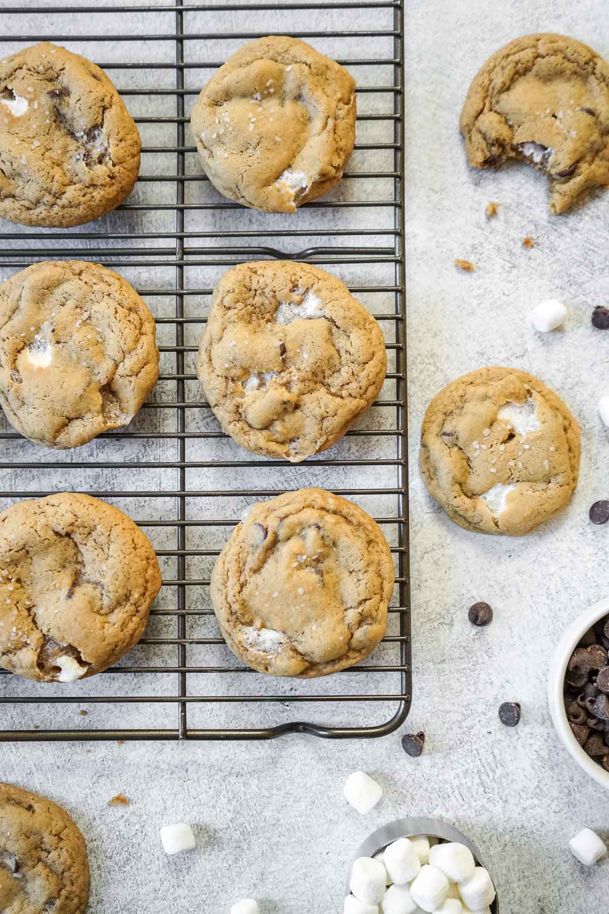 Several chocolate chip marshmallow cookies on a cooling rack.