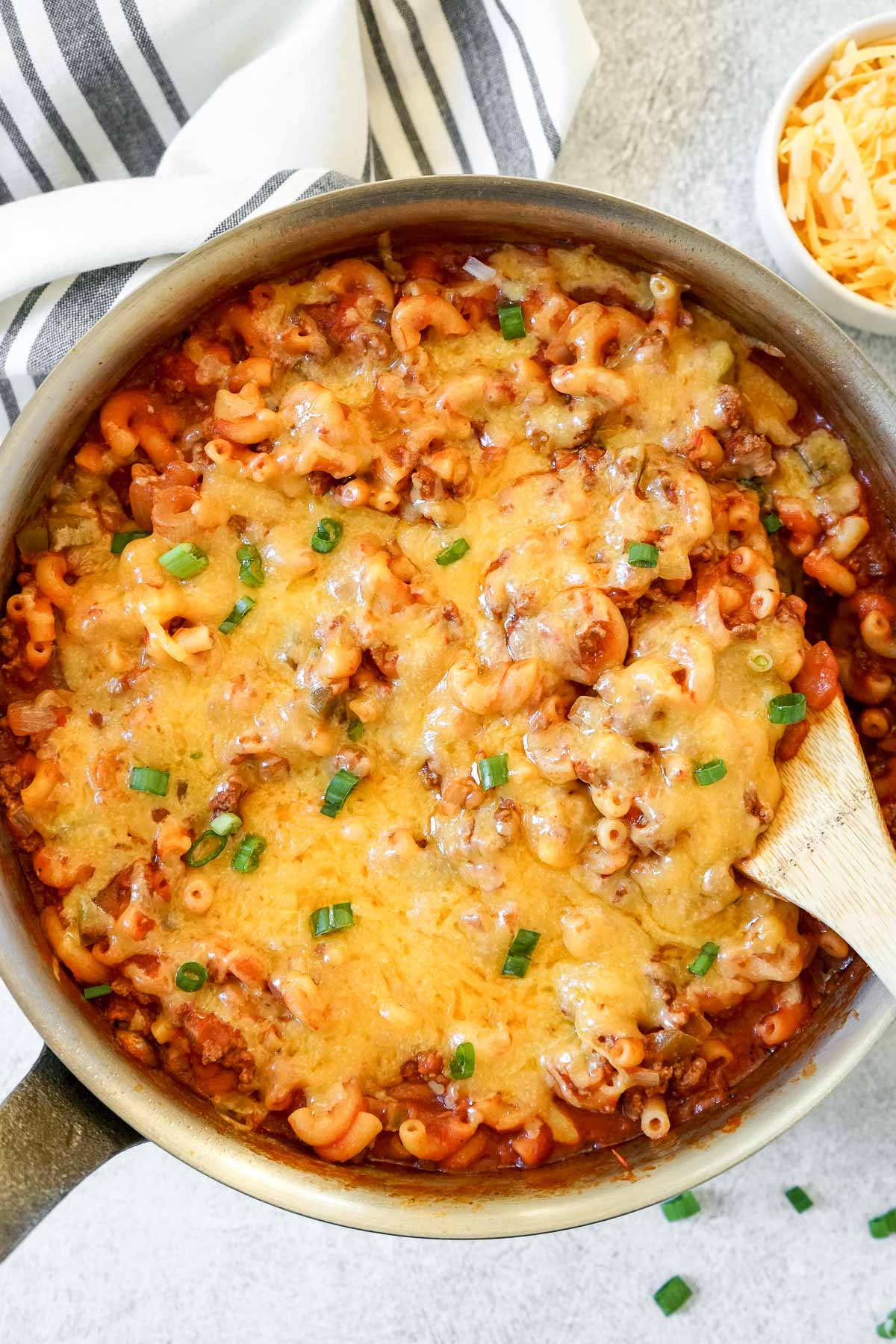 Easy one pot slumgullion in a large skillet with extra cheese on the side. 