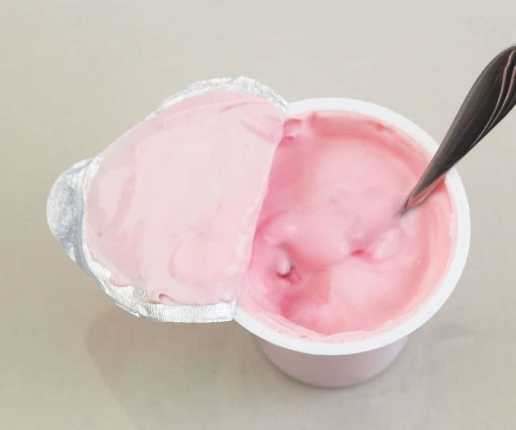A cup for yogurt with a spoon.