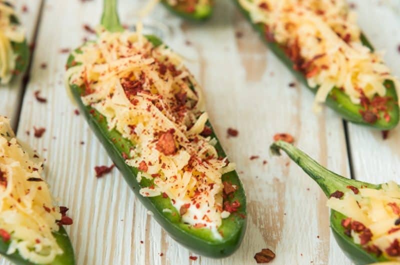 Jalapeno poppers on a wooden table.
