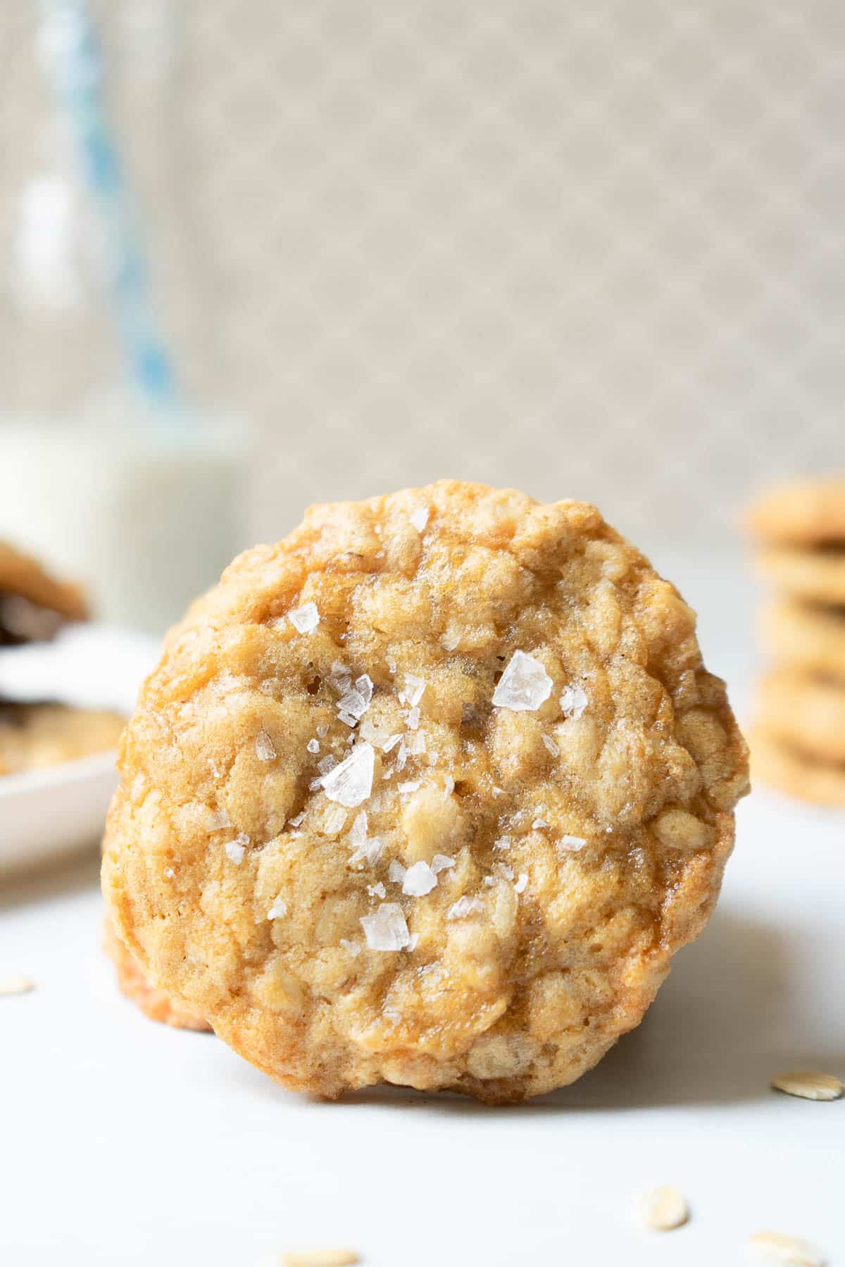 Up close photo of an oatmeal cookie sprinkled with flakey salt.
