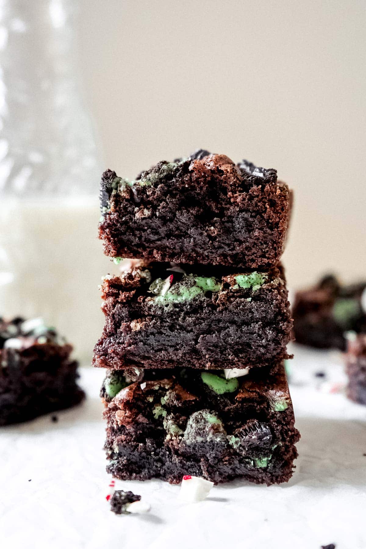 Three Oreo peppermint brownies stacked on top of one another.