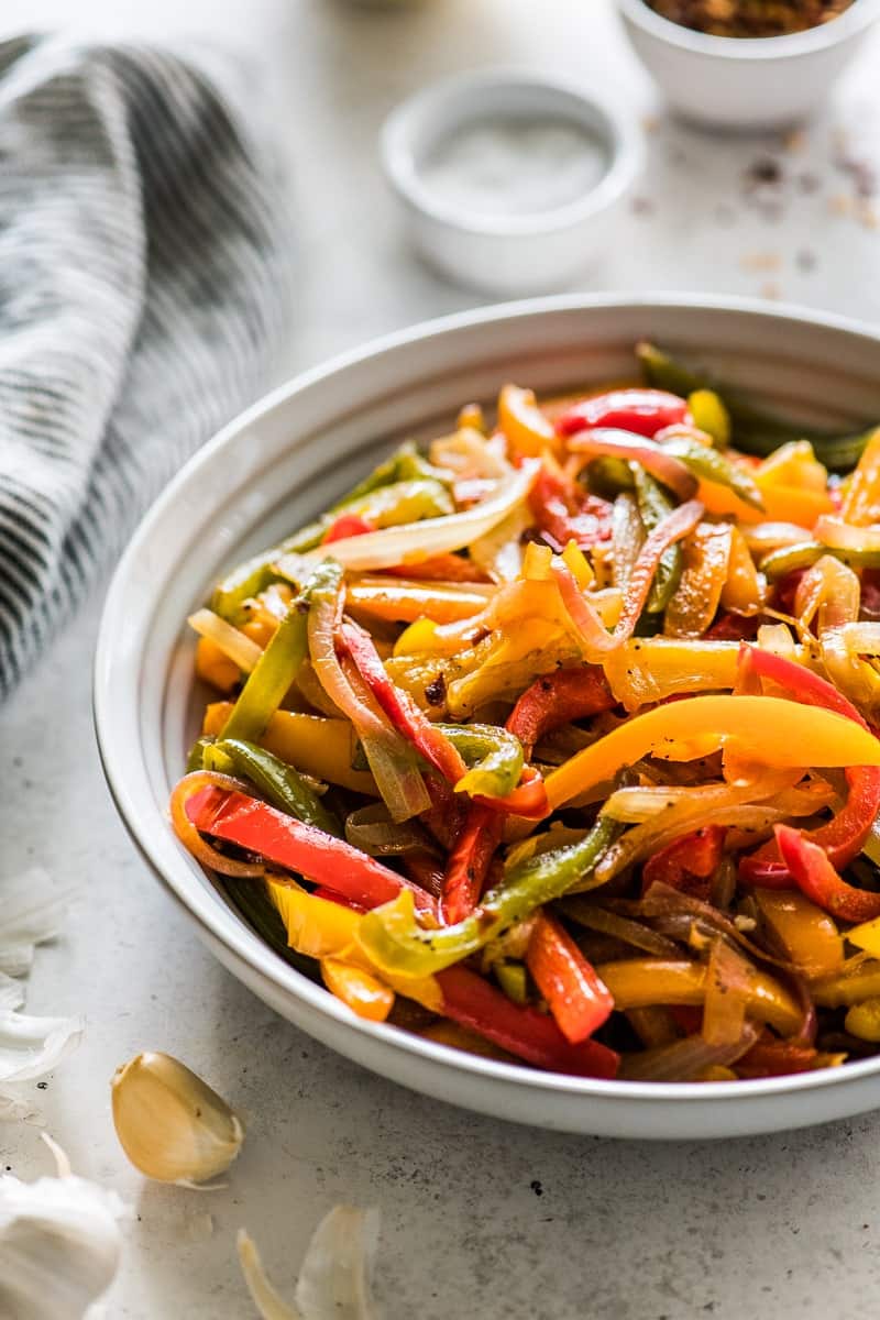 A bowl of peppers and onions which is a good vegetarian topping option for nachos.
