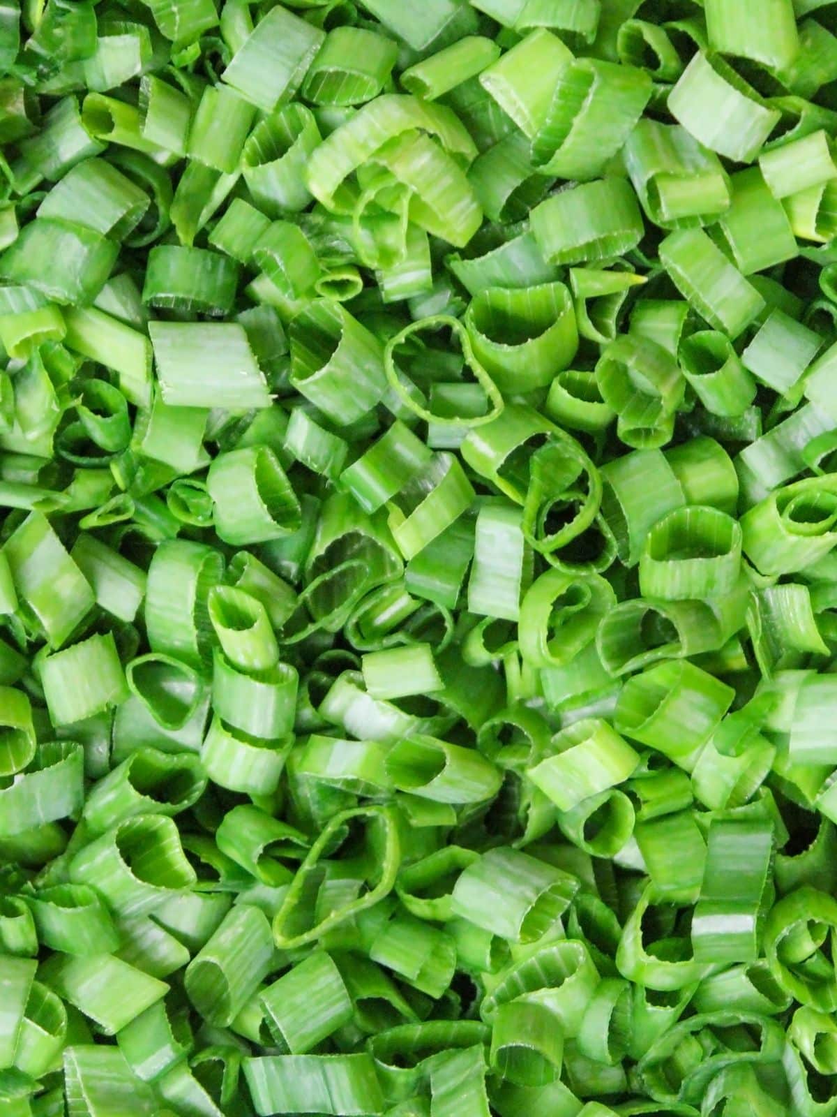 Chopped scallions on a plate--scallions are a traditional nacho topping. 