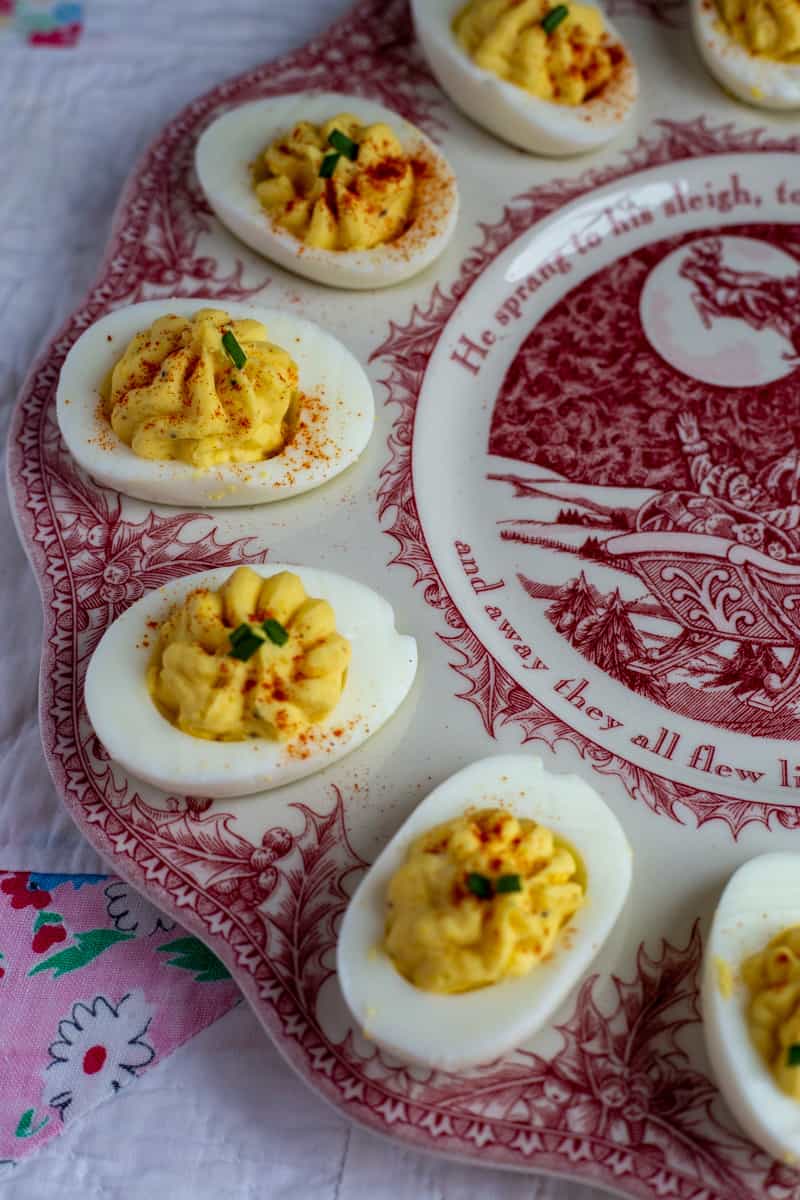Classic deviled eggs on a red egg platter.