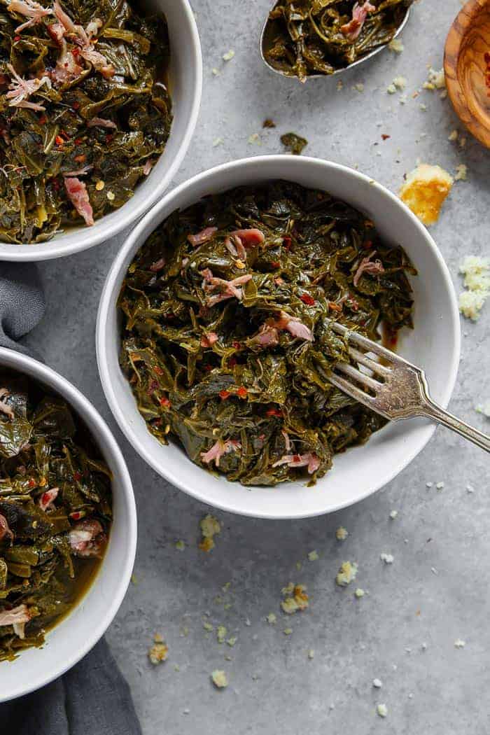 Two bowls of southern style collard greens.