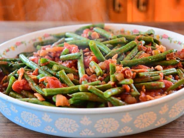 Pioneer woman's green beans and tomatoes in a large blue bowl.