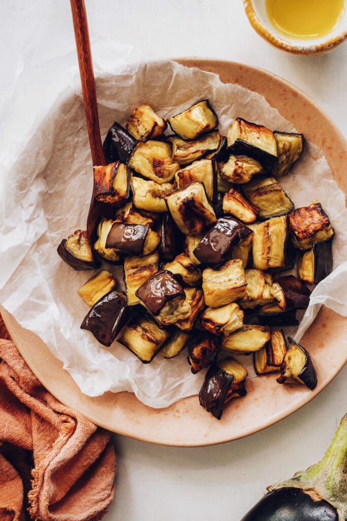 A plate full of roasted eggplant. 