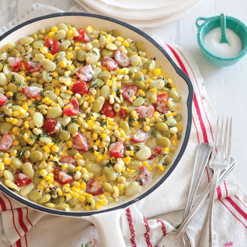 A large serving dish with creamy succotash.