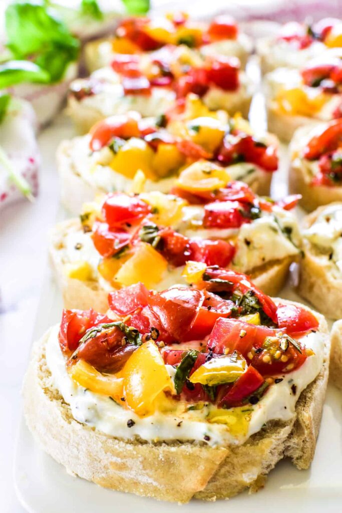Ricotta crostini topped with fresh tomatoes and herbs. 