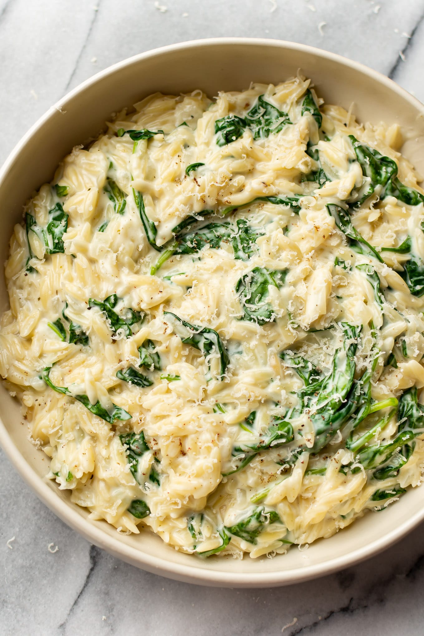 A bowl of creamy orzo and spinach.