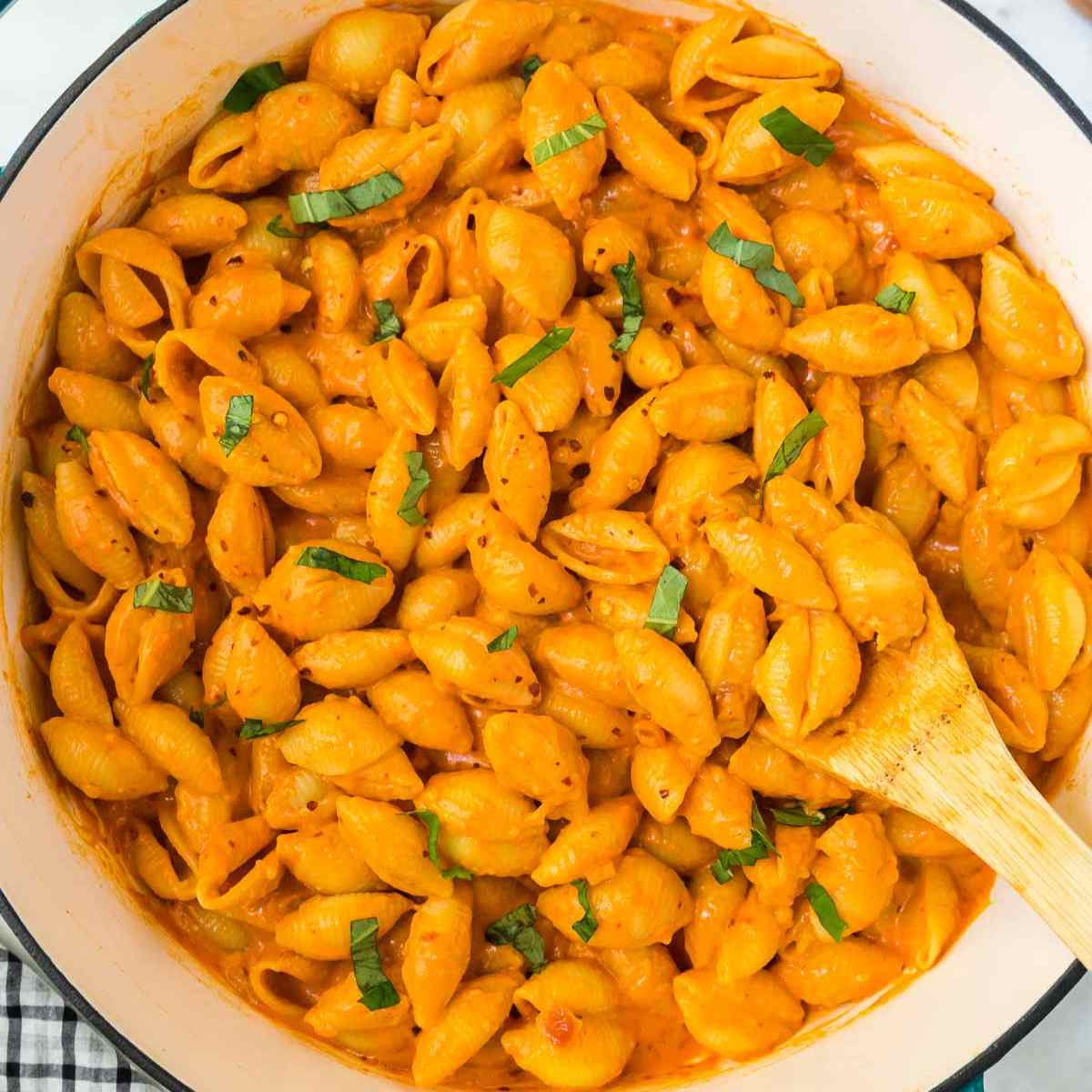 Featured image for Gigi Hadid Pasta recipe in a large pan with a wooden spoon.