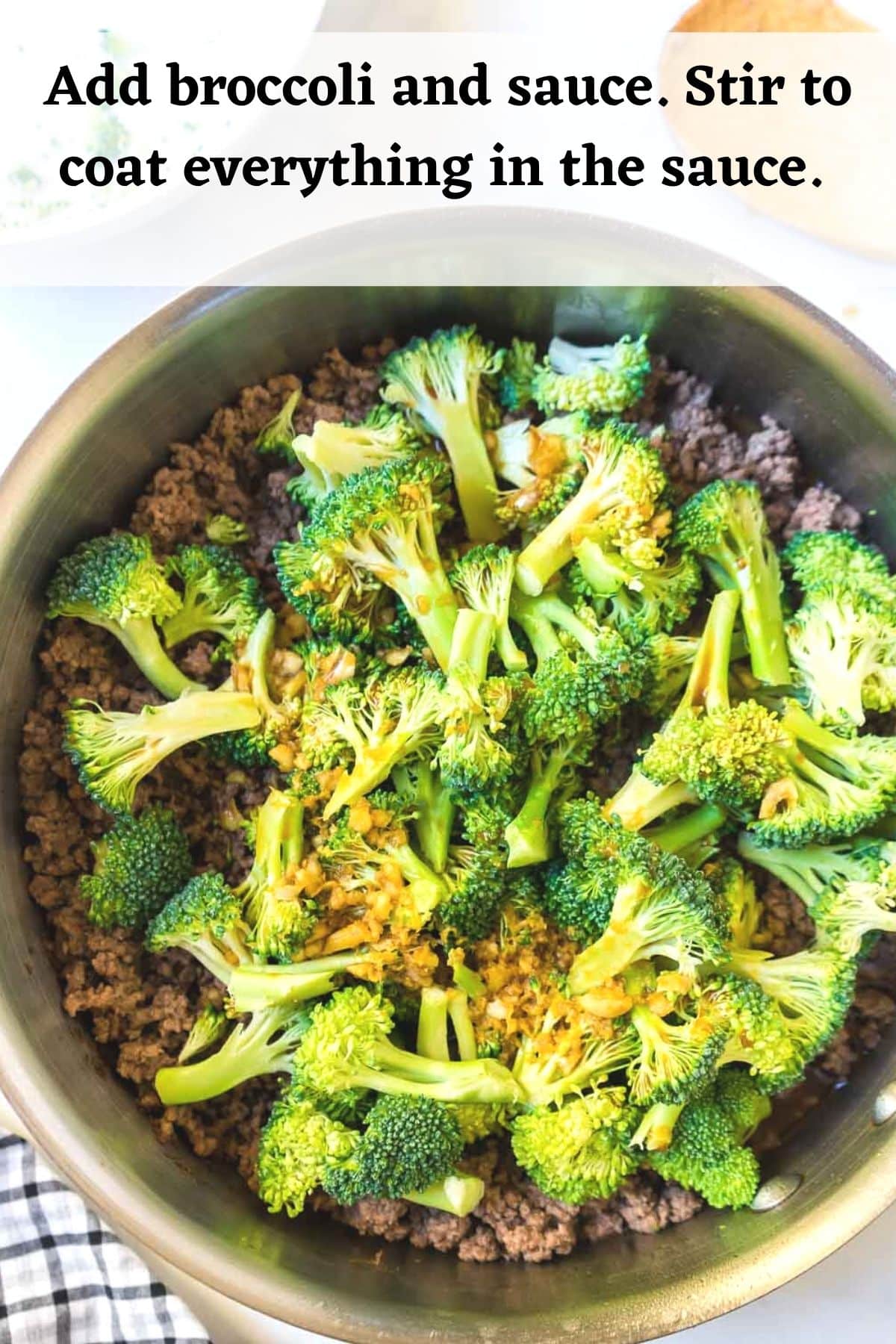 Ground beef and broccoli with sauce being added.