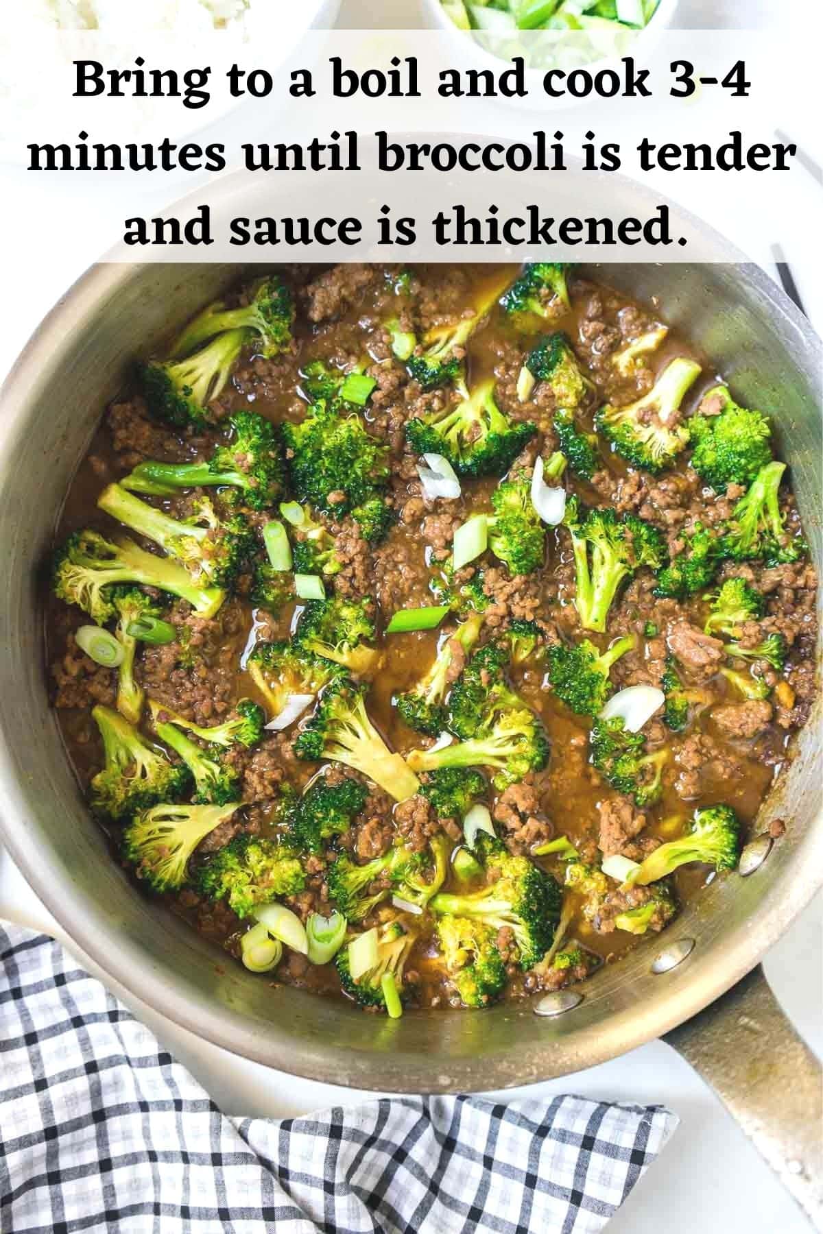 Ground beef and broccoli cooking in a large pan.