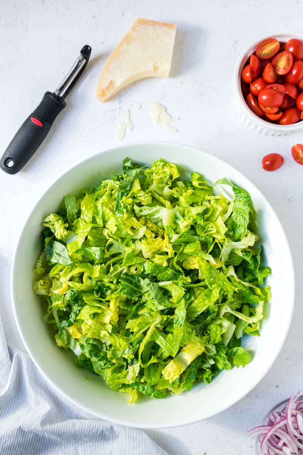 Romaine lettuce in a large white salad bowl.