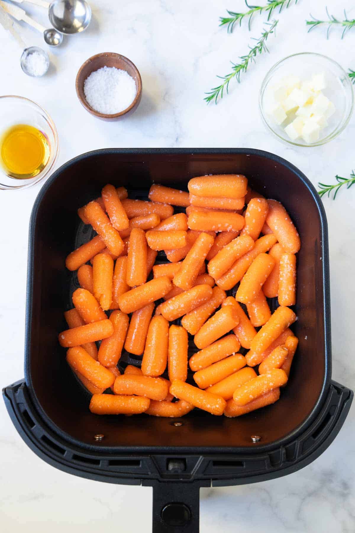 Air fryer roasted carrots in the air fryer basket.