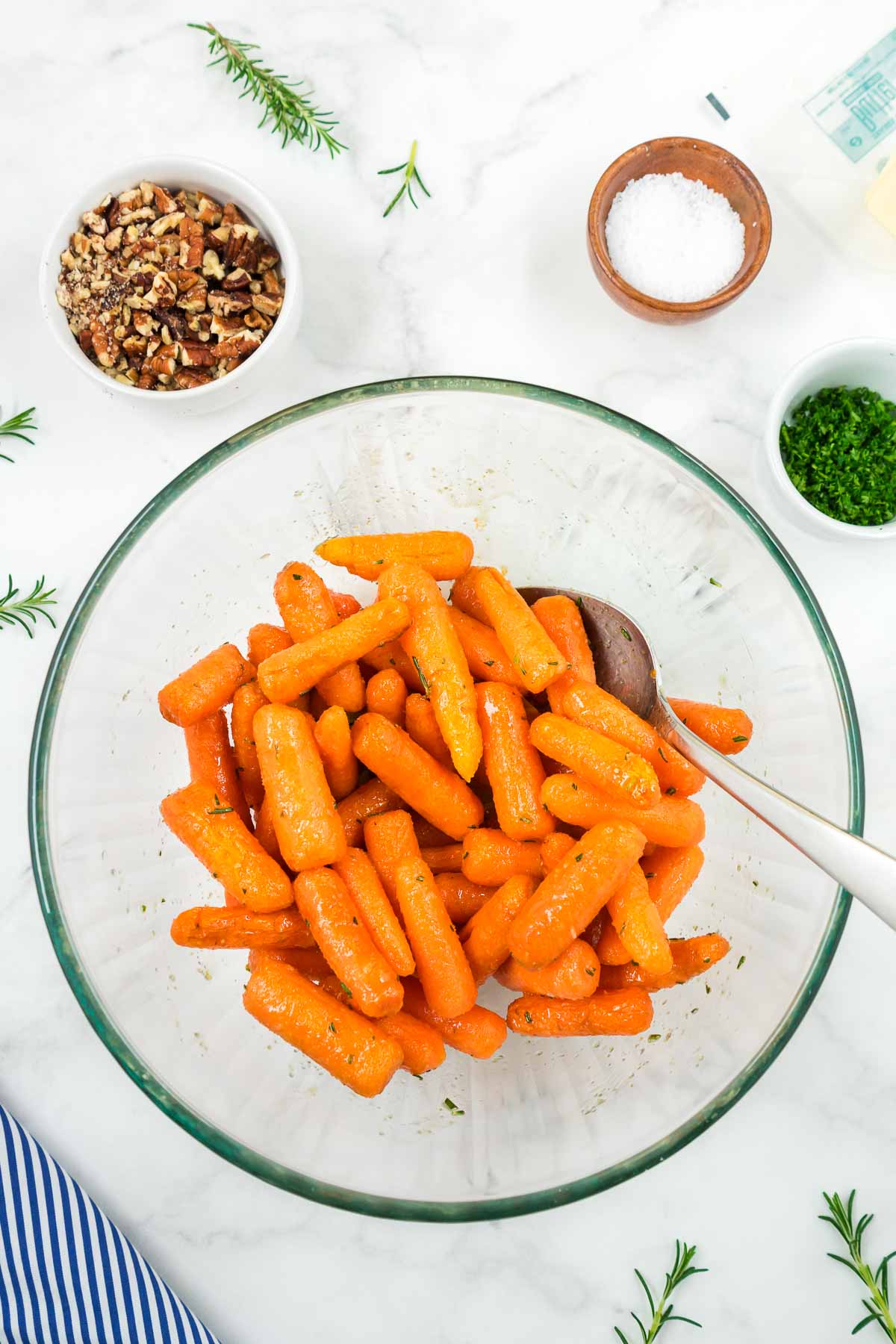 Air fryer baby carrots being tossed in the sweet glaze.