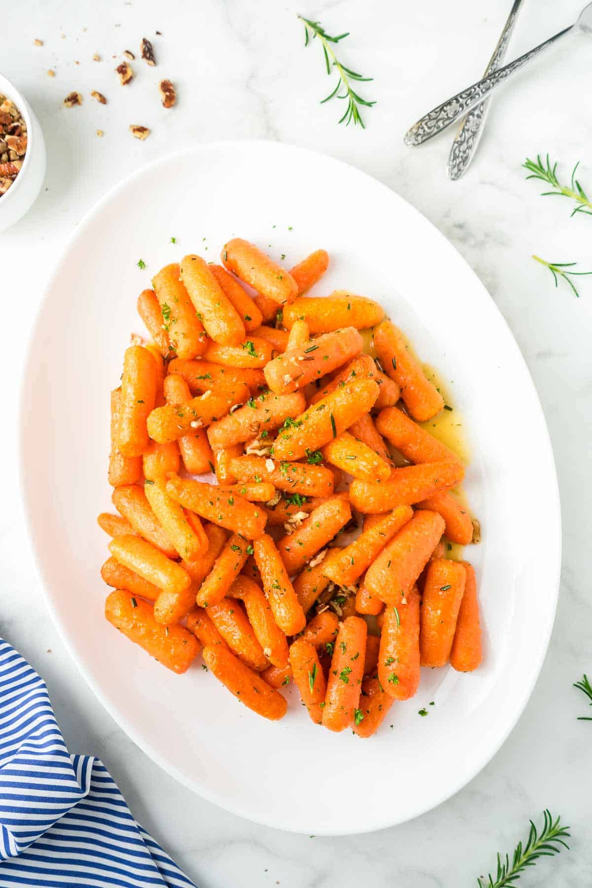 Air fryer baby carrots on a large white serving plate.